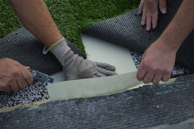 Metro New York artificial turf installation - cushion pad installation